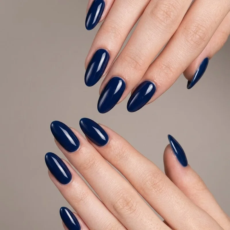 Navy blue nail polish swatched across different skin tones showing undertone versatility
