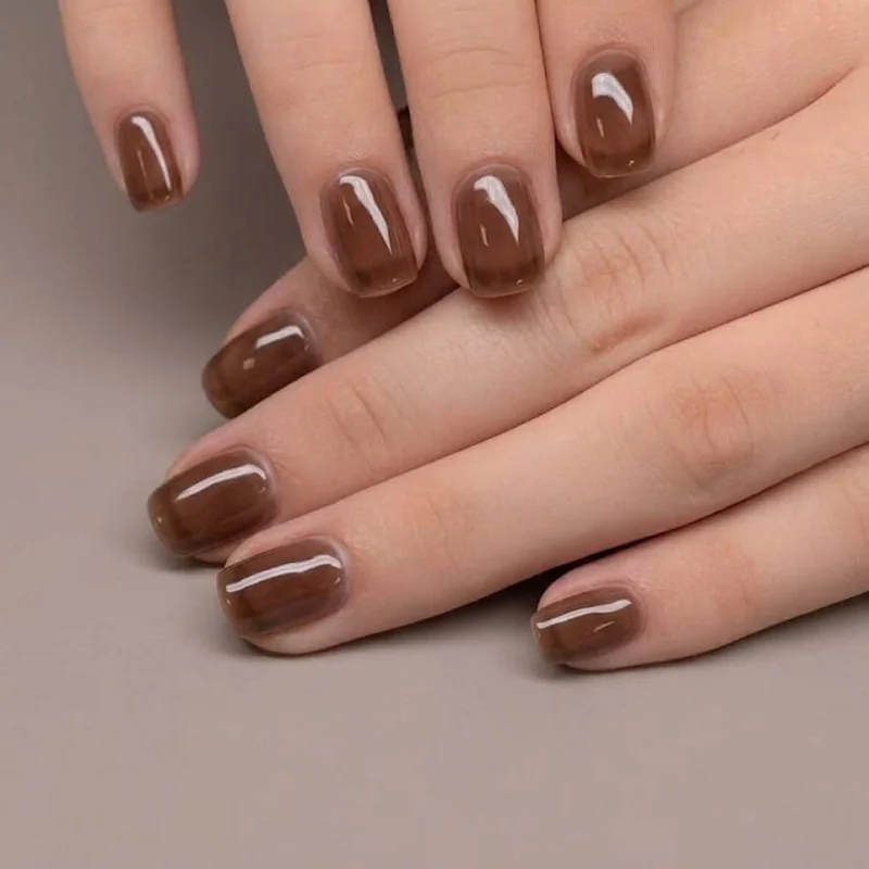 Short winter nails in a mocha chocolate brown shade, finished with a glossy gel-like glaze for the cold winter season