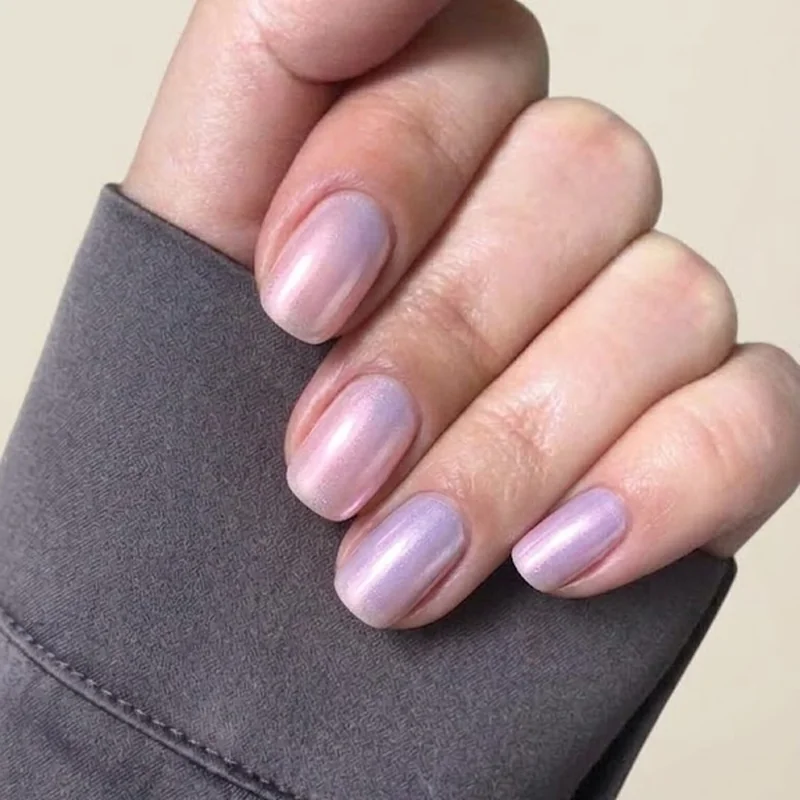 Soft pink lavender pearl chrome finish on short nails showing gentle winter mirror shine