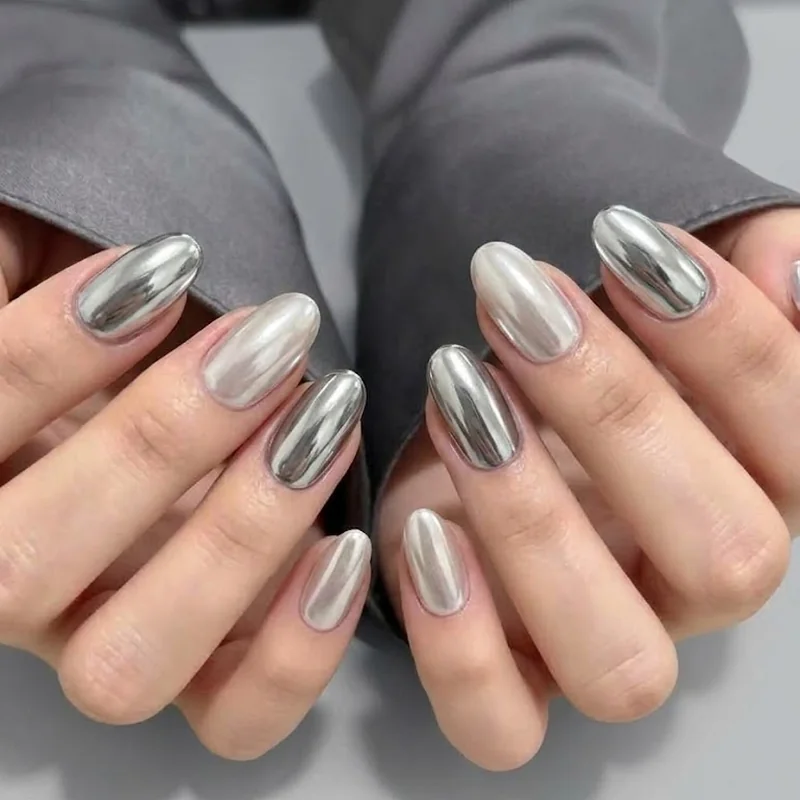 Close-up mirror-finish chrome manicure in silver and pearl showing true reflective winter shine