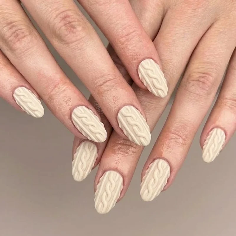 3D sweater textured nail art in cream, mimicking knit fabric for cozy winter nails