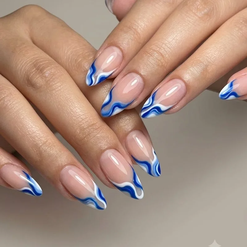 Abstract wavy French tip nail art in cobalt blue and white for bold winter nails