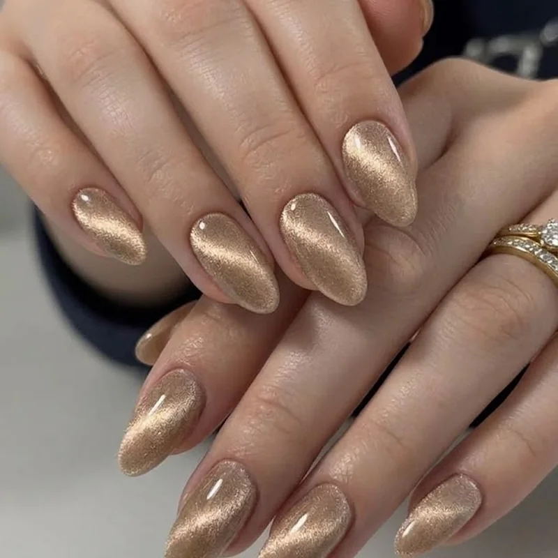 Champagne gold velvet cat eye manicure, a cozy textured winter nail idea for 2026