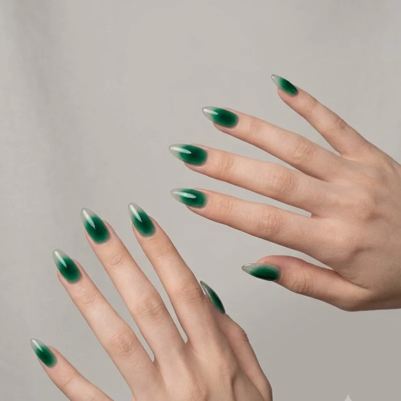 Deep emerald aura gradient nail design as a bold winter statement manicure