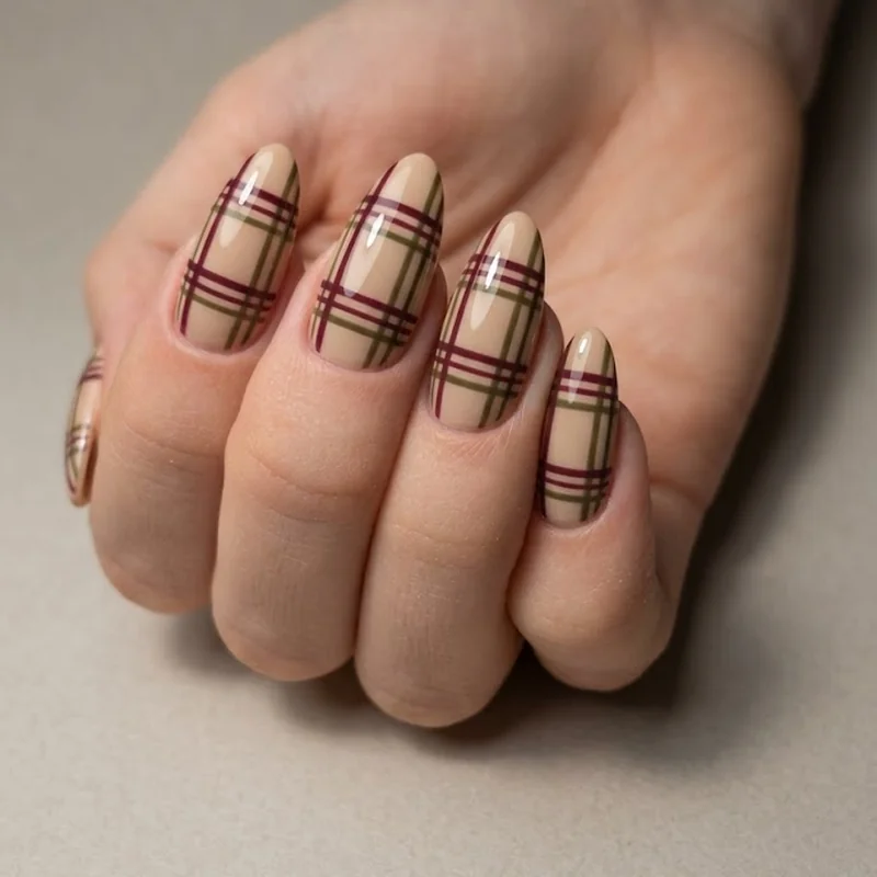 Plaid pattern nail art in burgundy and olive for a cozy winter nail design