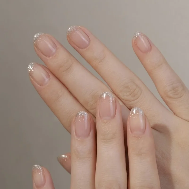 Short round nails with subtle glitter dip tips for winter nail ideas