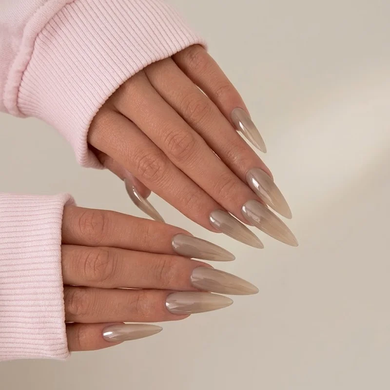 Winter nail trends 2026 cashmere gel manicure styled against a cozy knit sweater in warm light
