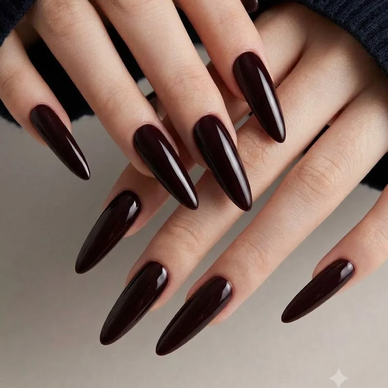 Deep wine near black glossy manicure with elegant contrast against winter clothing styling