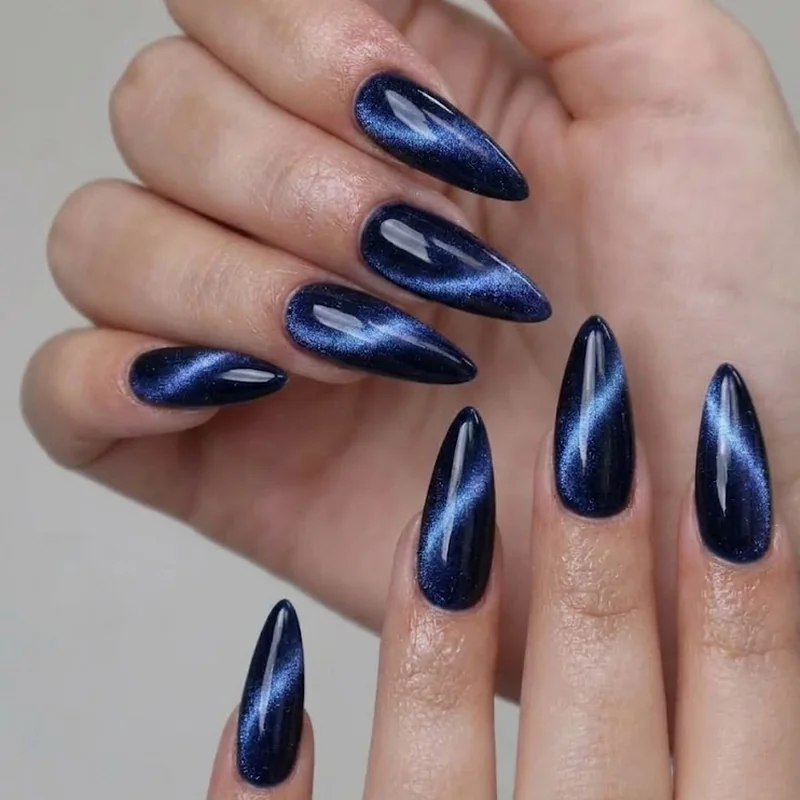 Velvet cat eye midnight blue manicure showing magnetic shimmer effect for winter nail trends