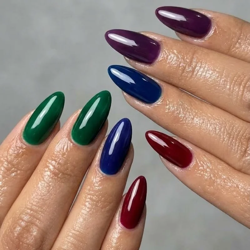 Coordinated bridesmaid winter wedding nails in complementary jewel tone manicures