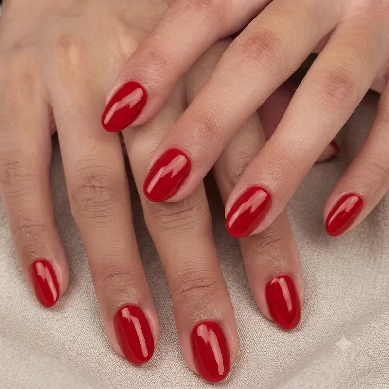 Recreate at home red manicure flatlay with layered polish bottles and finished nail set
