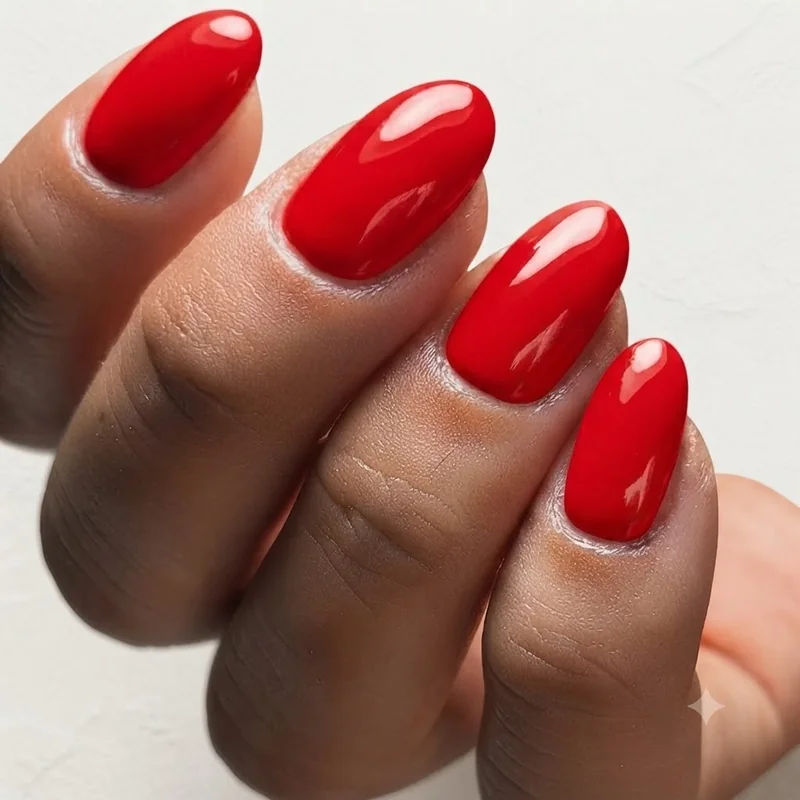 Bold red manicure styled as a signature confidence statement nail look editorial shot