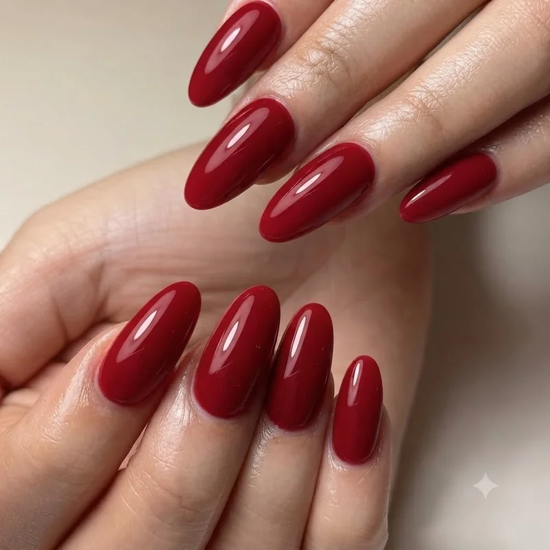 Close up detail of Zendaya red nail polish colour against white suit fabric texture