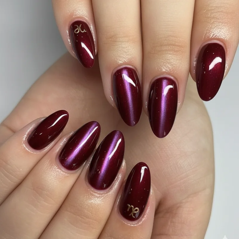 Capricorn short nails on oval and squoval shapes with garnet cat eye gel and micro French tip designs that look intentional and polished