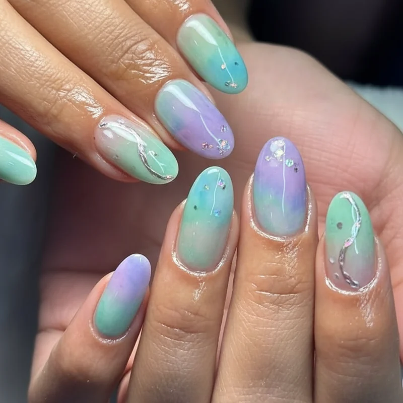 Jelly seafoam aqua and soft lavender watercolour gradient pastel Pisces season nails on oval almond shape for dreamy finish