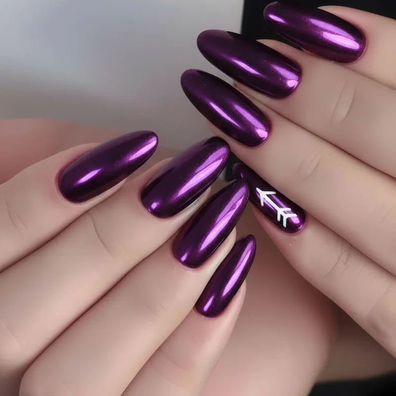 Close-up of Sagittarius nail art showing deep purple chrome base with negative space arrow accent on almond shaped nail