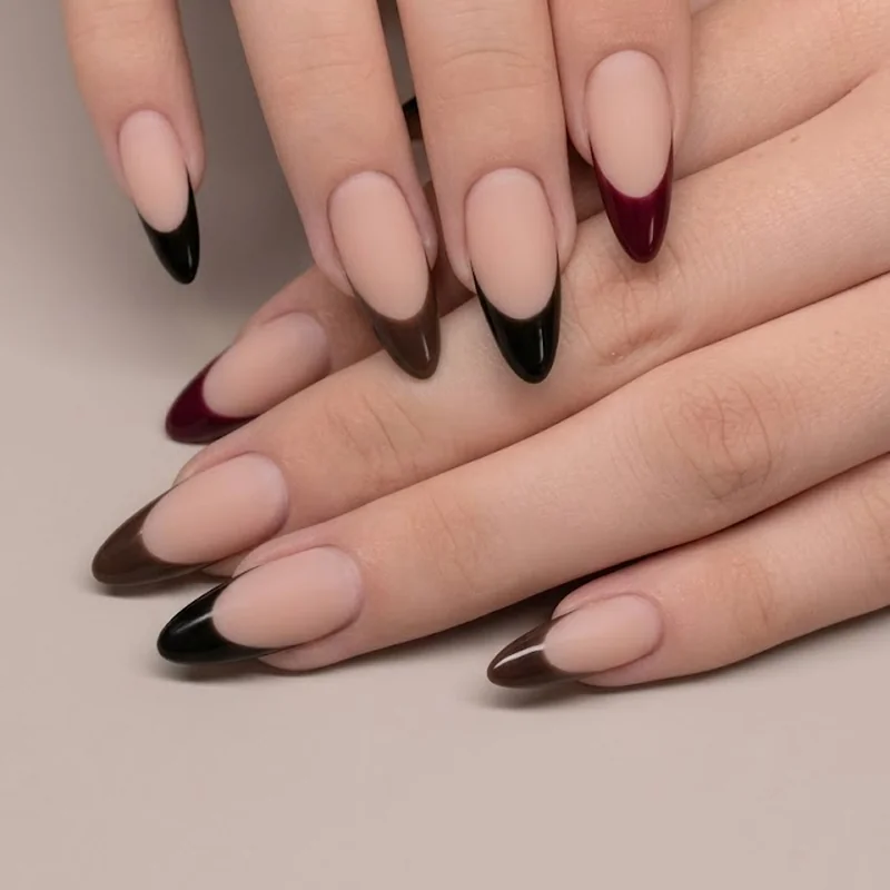 Moody black, burgundy, and espresso French tips on a nude base