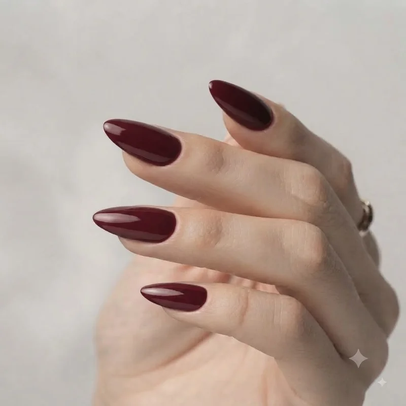 Deep wine burgundy glossy almond nails, a quiet luxury fall manicure