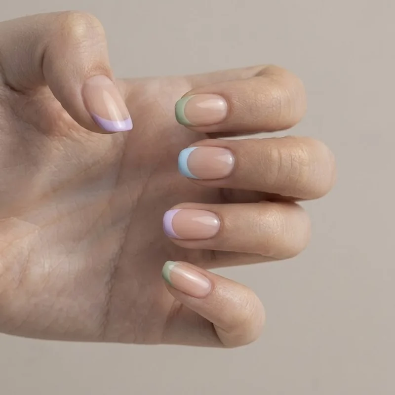 Pastel lavender, sage, and baby blue micro French tips over a sheer base