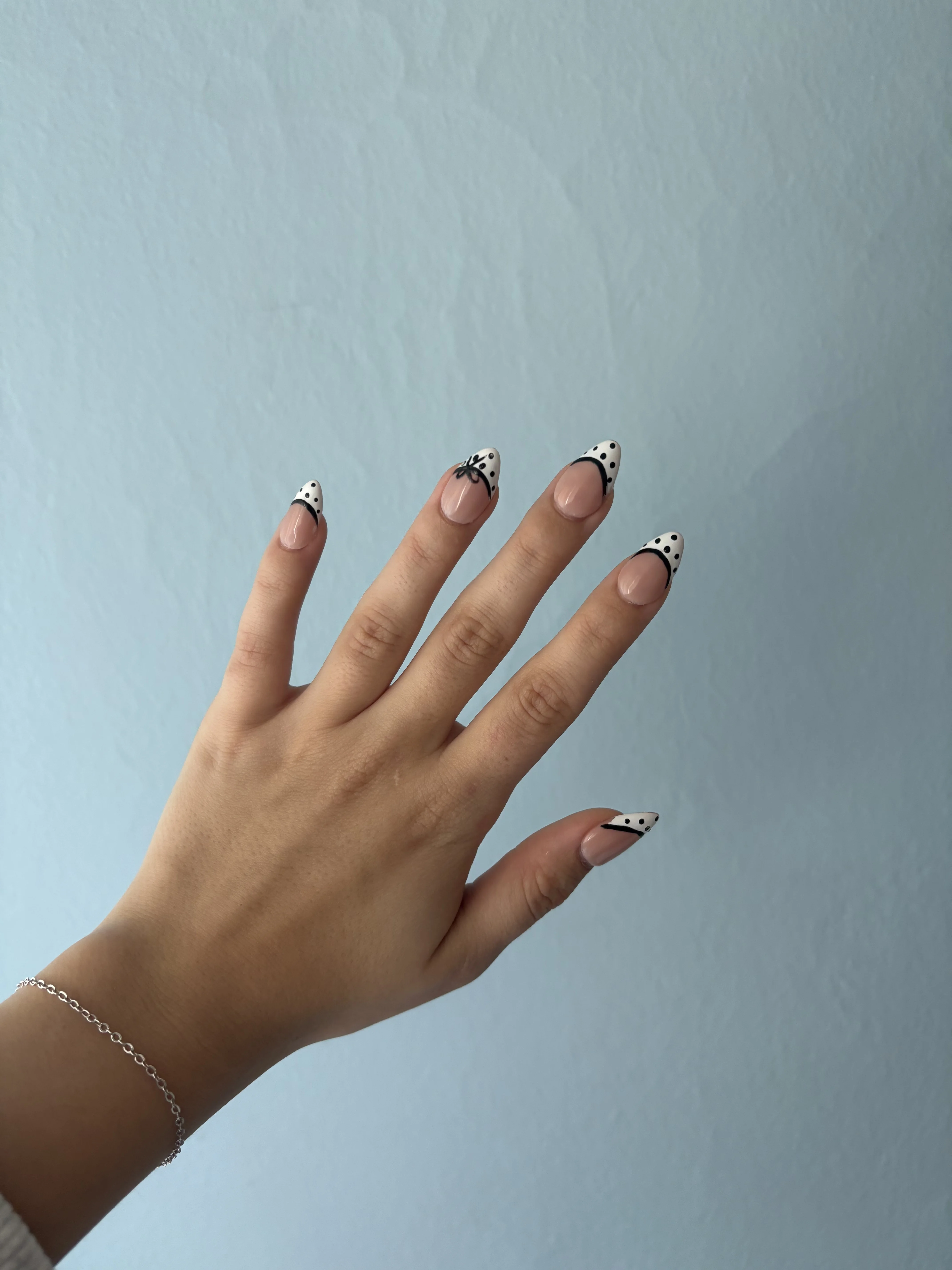 Peyton Combs nail studio Shelby Township Michigan featuring pink flower wall neon nails sign and full gel polish collection shelves