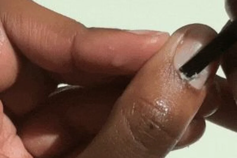 Proper cuticle oil application technique massaging into nail beds for moisture and strength to prevent brittle breaking nails