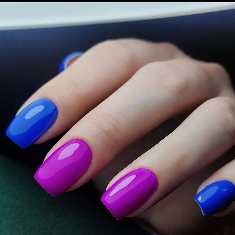 Deep cool undertone skin wearing electric blue fuchsia bold statement nail colors vibrant contrast