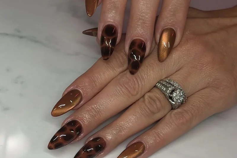 Fall 2025 modern tortoiseshell nail art with sheer application and negative space design sophisticated pattern