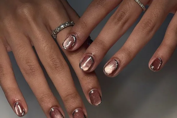 Glass nails trend 2025 showing ultra glossy transparent natural nail finish for healthy look prioritizing nail care wellness