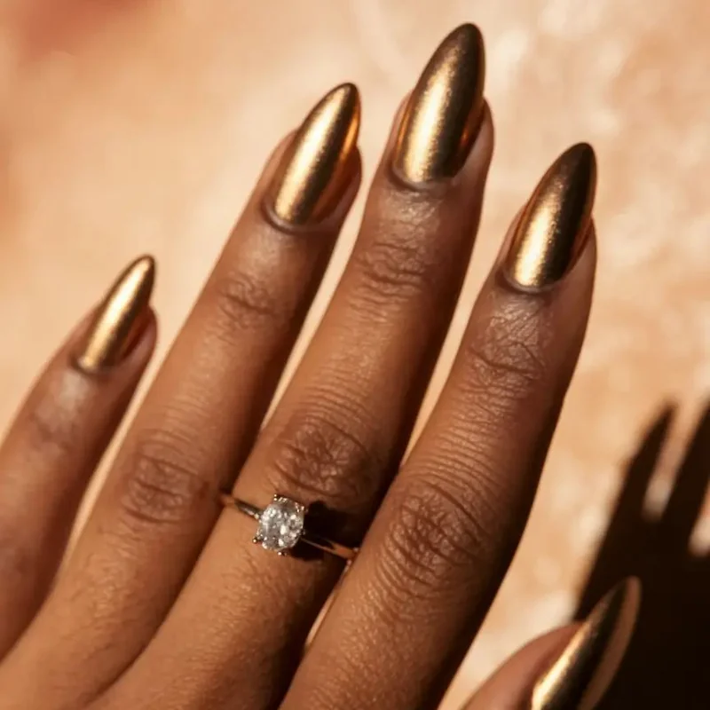 Olive skin tone displaying bronze gold metallic nail polish luxurious finish complementary warmth