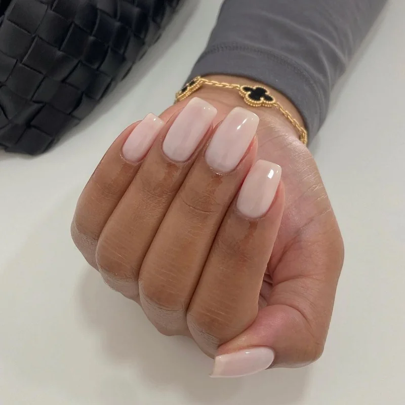 Professional woman reviewing business documents with short squoval nails practical office work manicure corporate