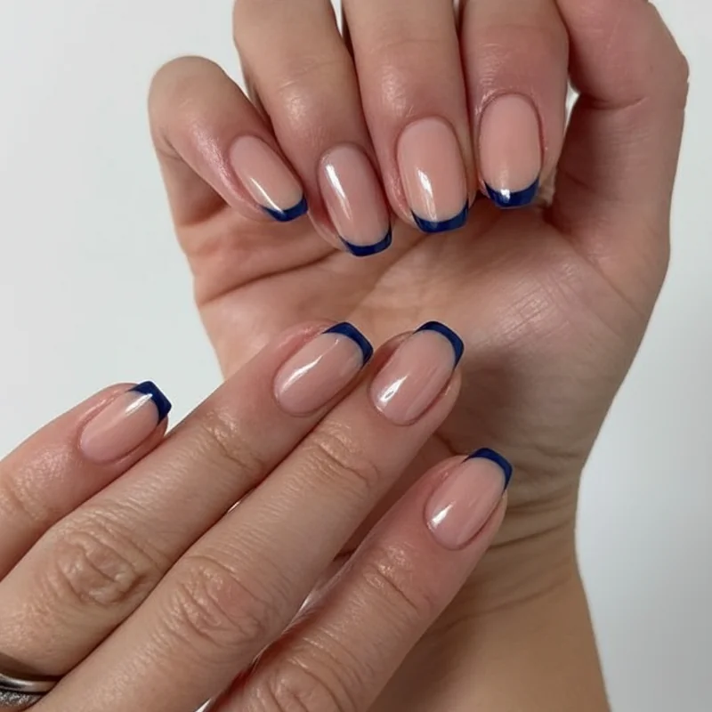 Coloured French tip nails in navy mocha and taupe on squoval shape demonstrating office-appropriate alternatives to classic white tip for professional women 2026