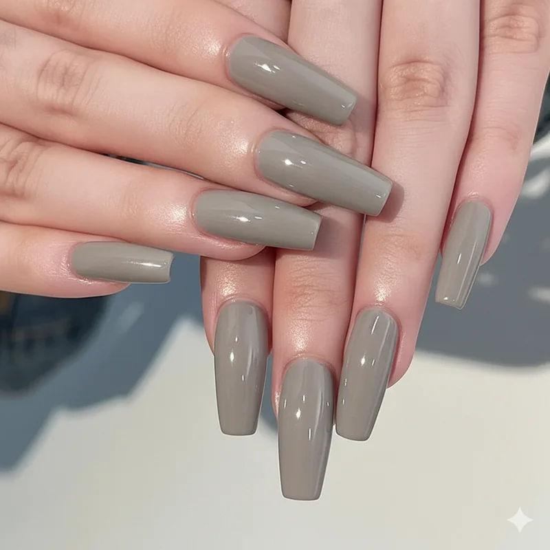 Greige quiet luxury nail colour on squoval nails photographed in natural light showing the understated polish ideal for a first day at a new corporate job