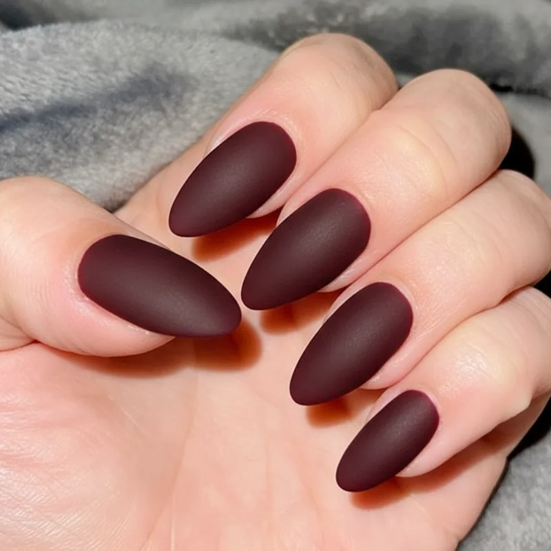 Matte versus glossy finish on dark burgundy nail comparing professional office appropriate looks on squoval shape for 2026