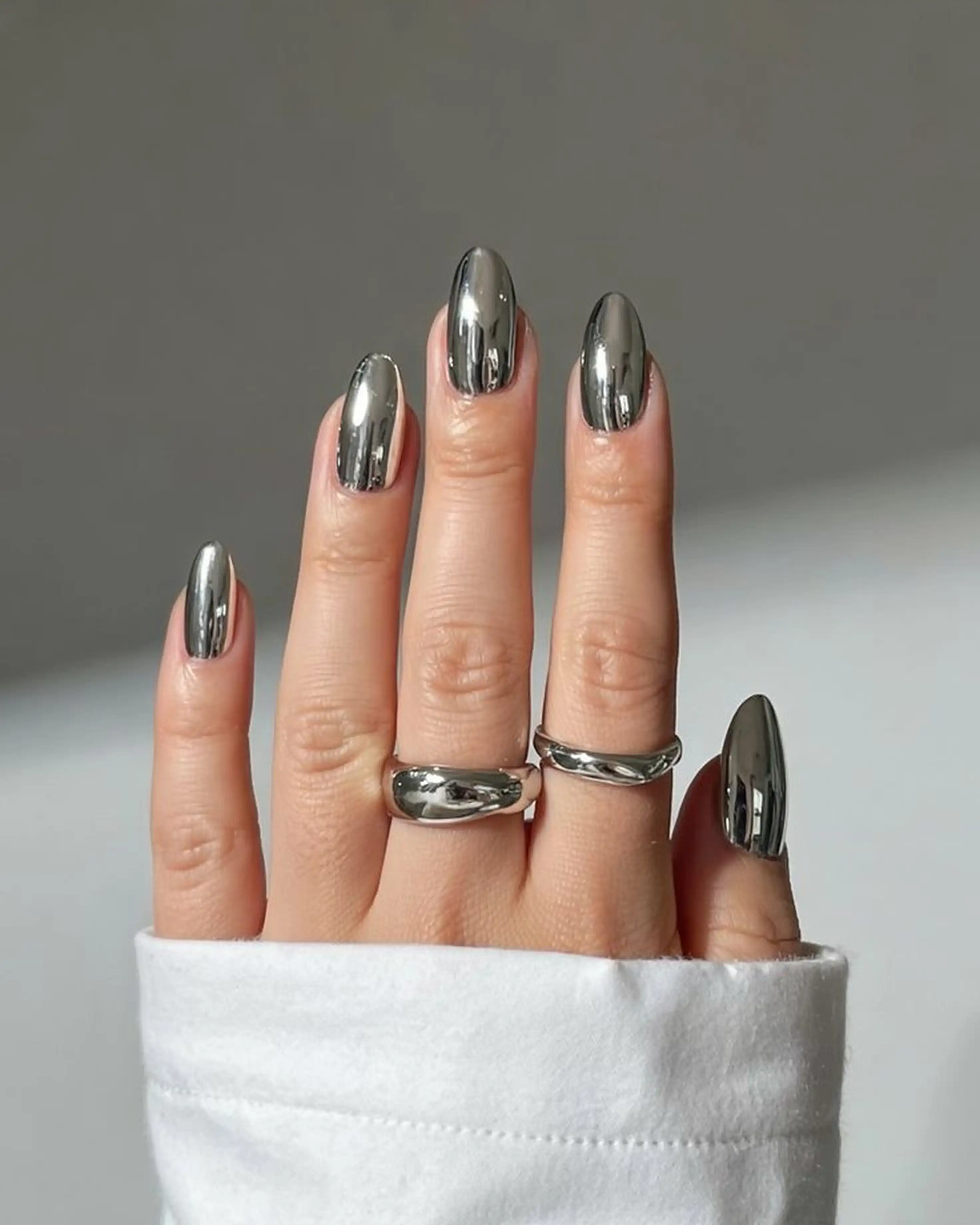 Chrome silver almond nails mirror finish with metallic reflective creating party manicure for night events