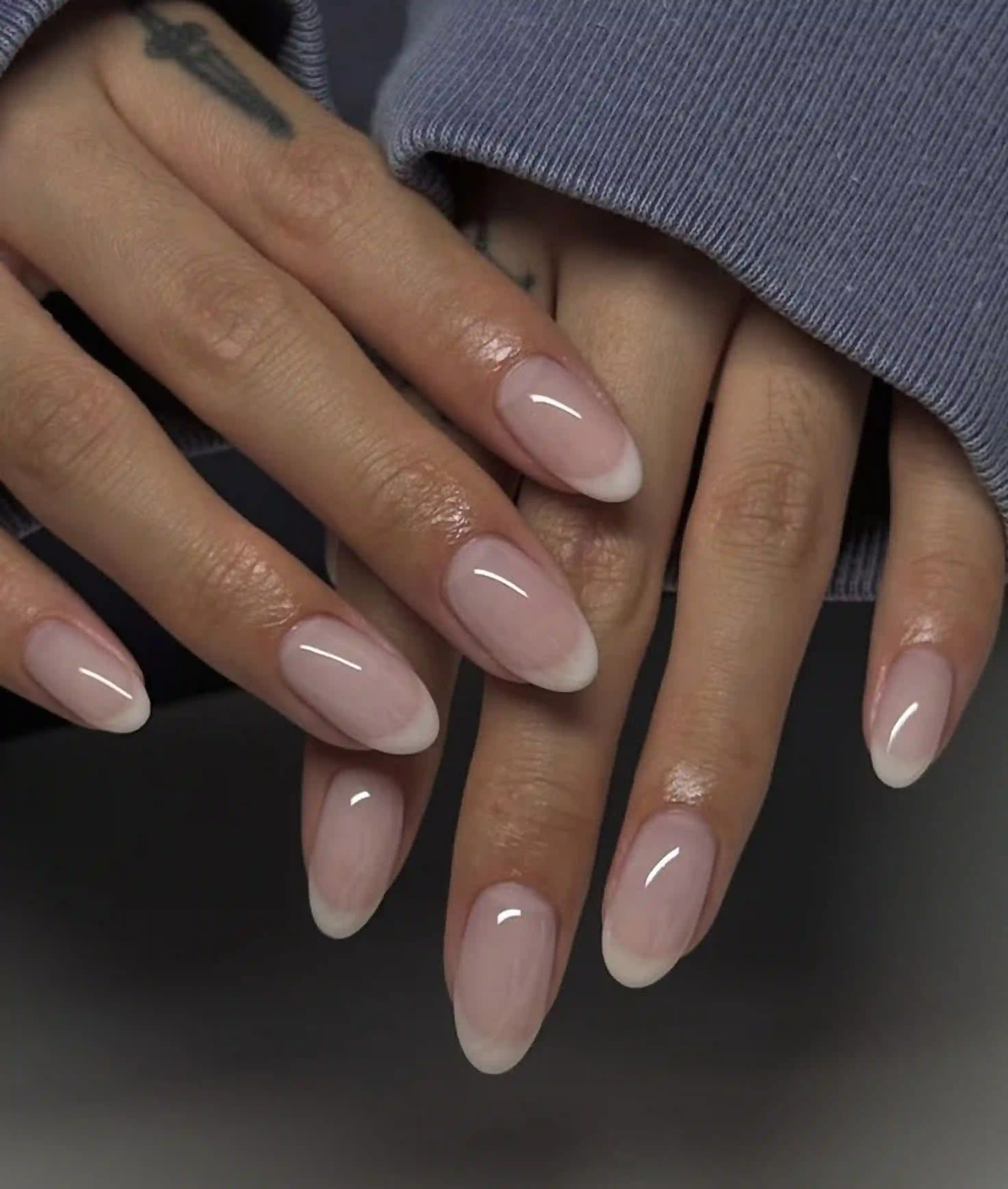 Micro french almond nails whisper thin tips creating quiet luxury professional manicure for elegant occasions