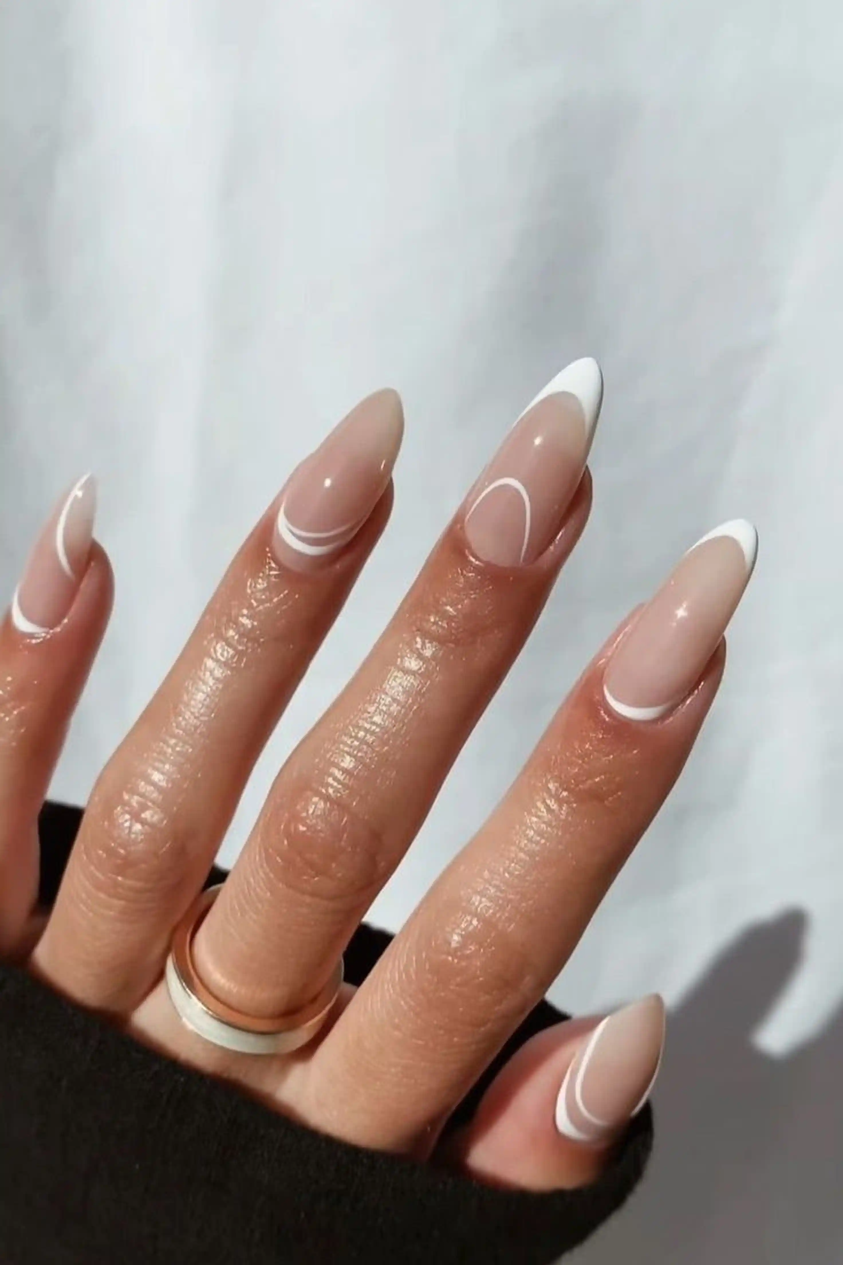 Negative space almond nails modern minimalist with clear nude creating artistic manicure for trendy look