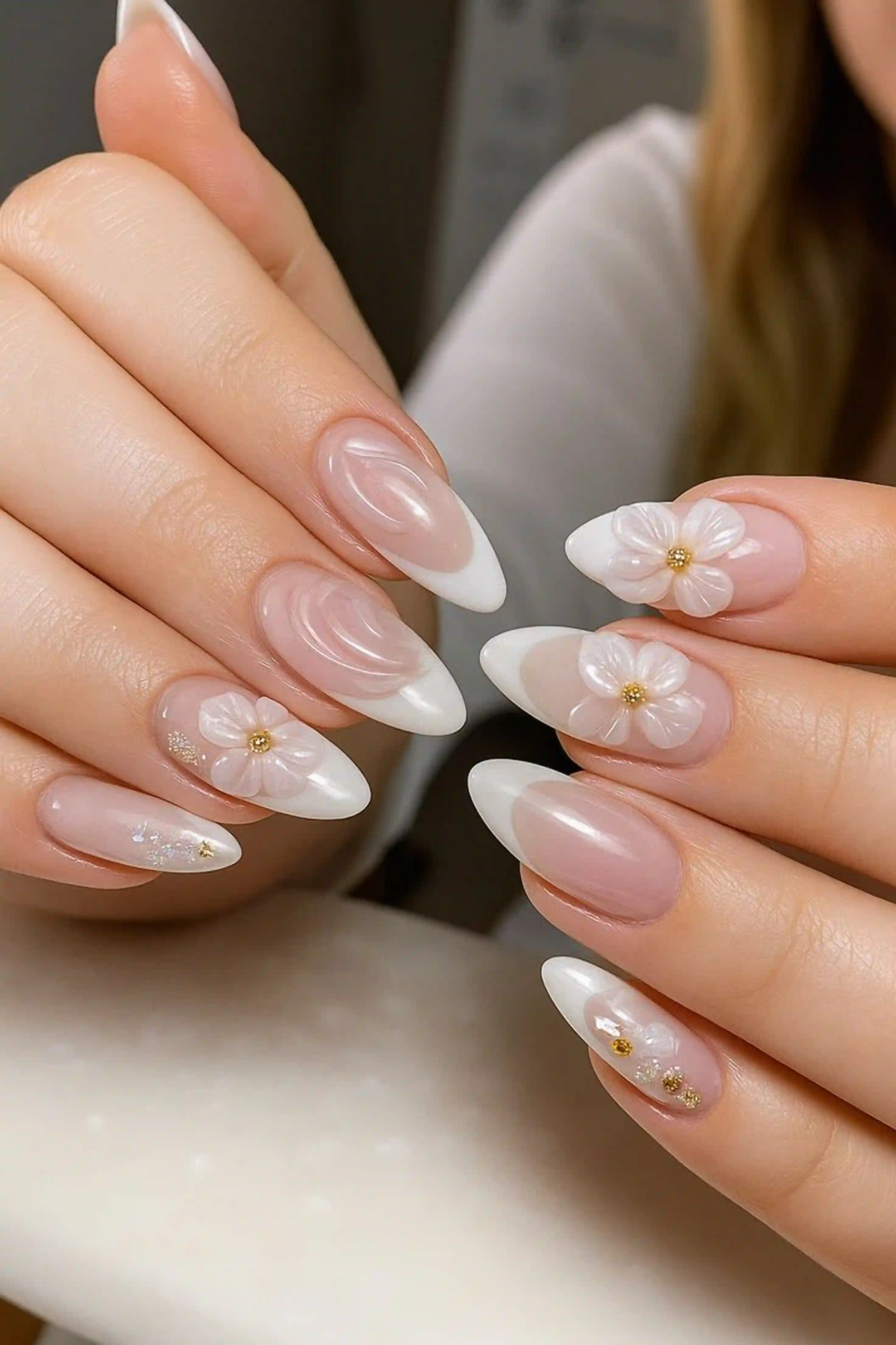 Pearl embellished almond white nails with 3d accents creating luxury wedding manicure design for bridal style