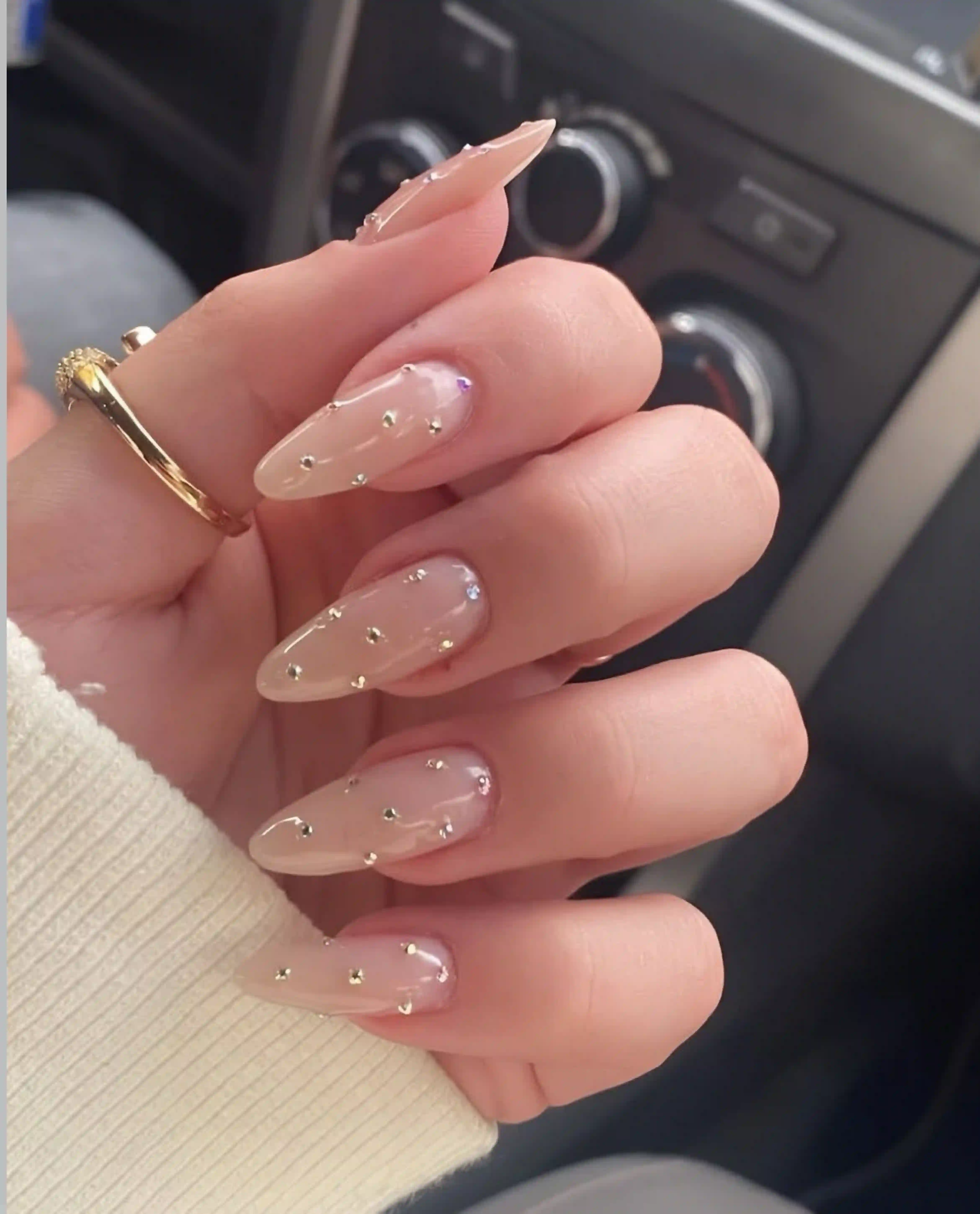 Rhinestone almond nude nails with crystal accent creating luxury wedding glamorous manicure for brides
