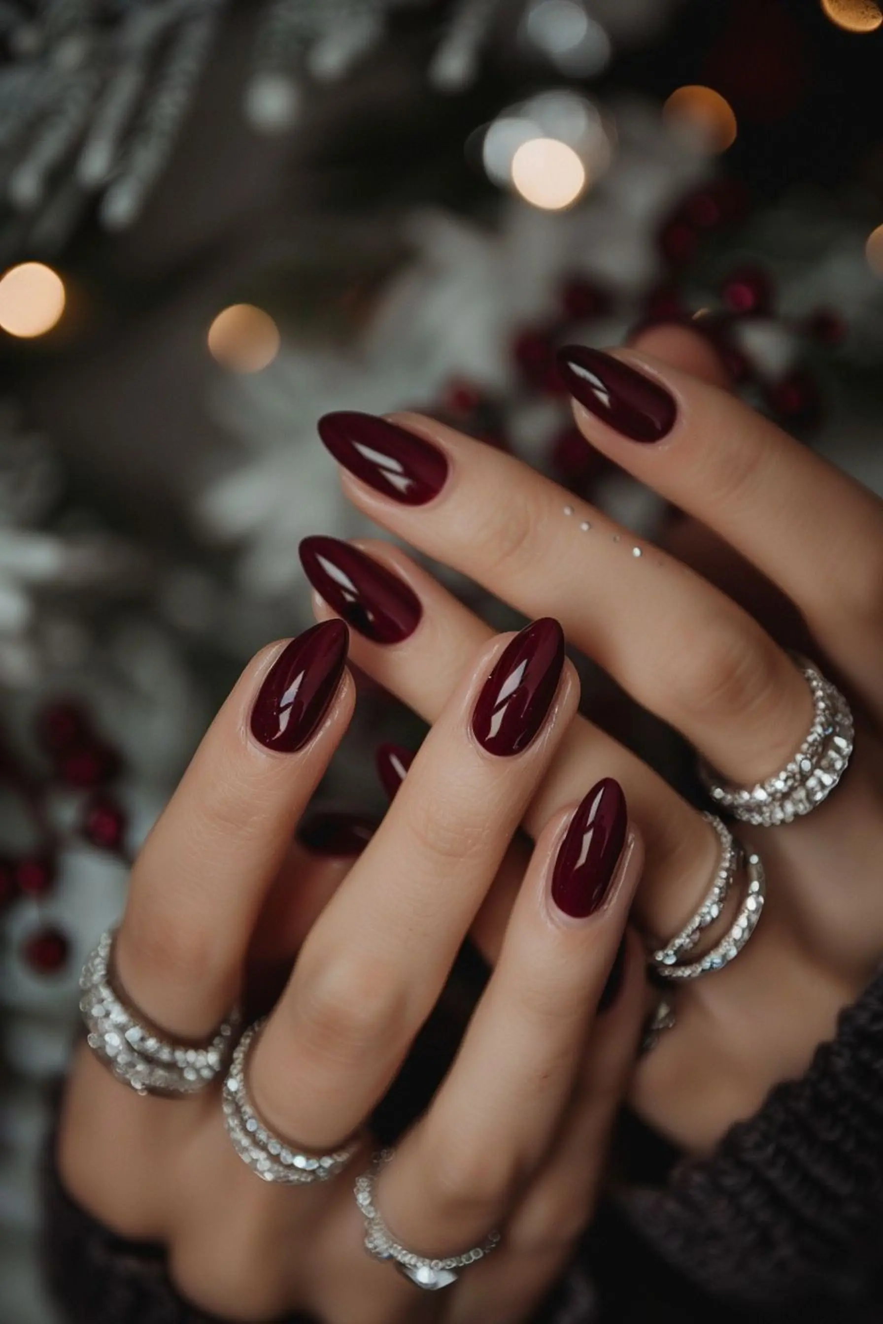 Deep burgundy squoval nails with rich wine color creating timeless elegant winter wedding manicure perfect for bridal party style