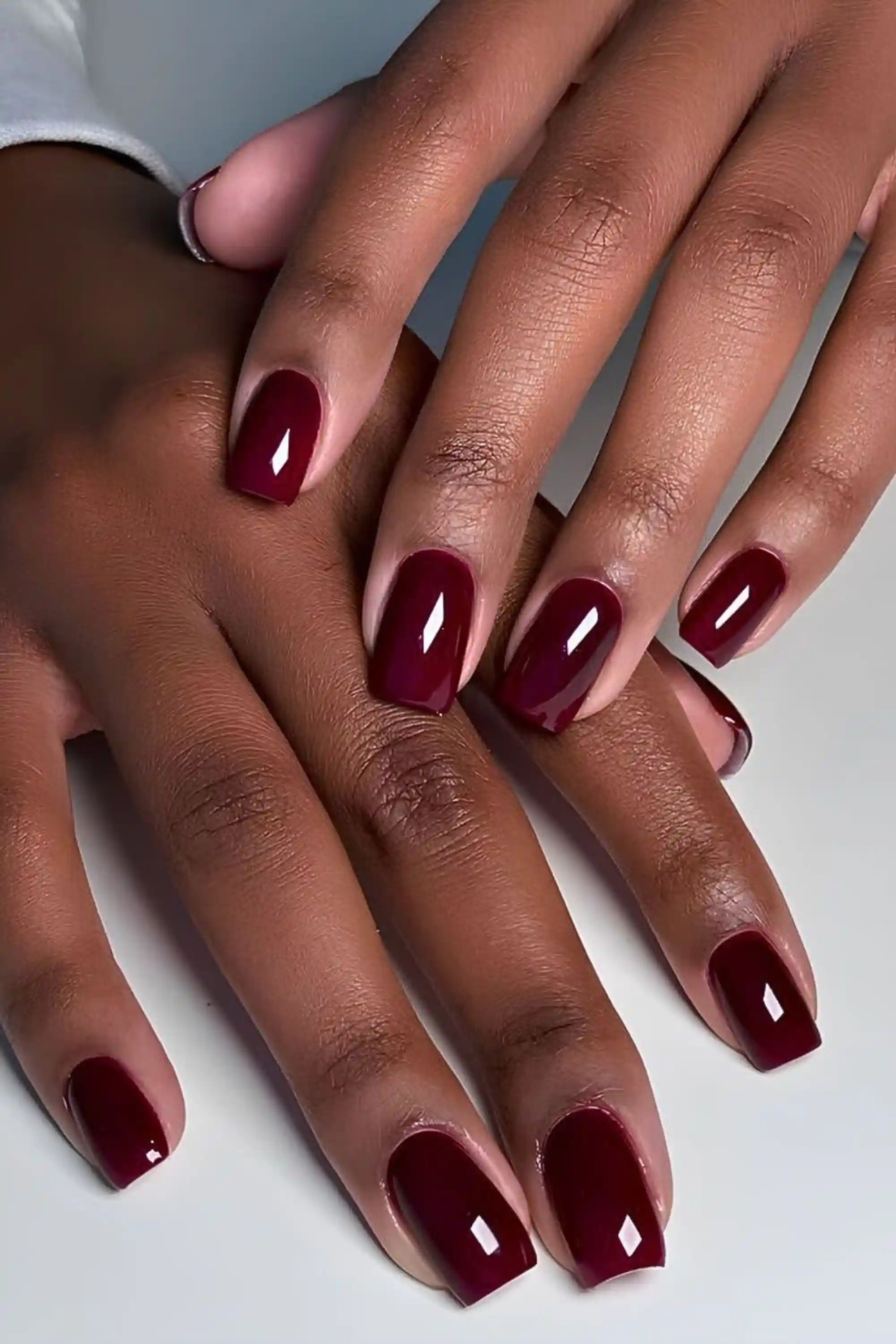 Merlot burgundy short nails with rich wine color creating office appropriate chic everyday winter manicure for professional wear