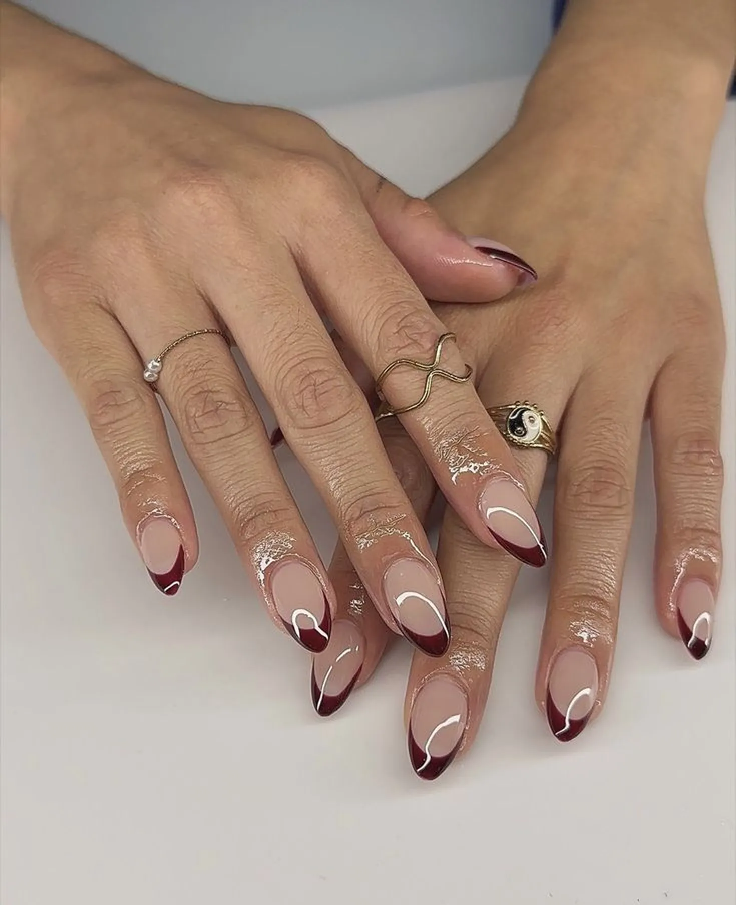 Wine red French tips with burgundy accent creating classic elegant winter nail art perfect for wedding and formal winter events