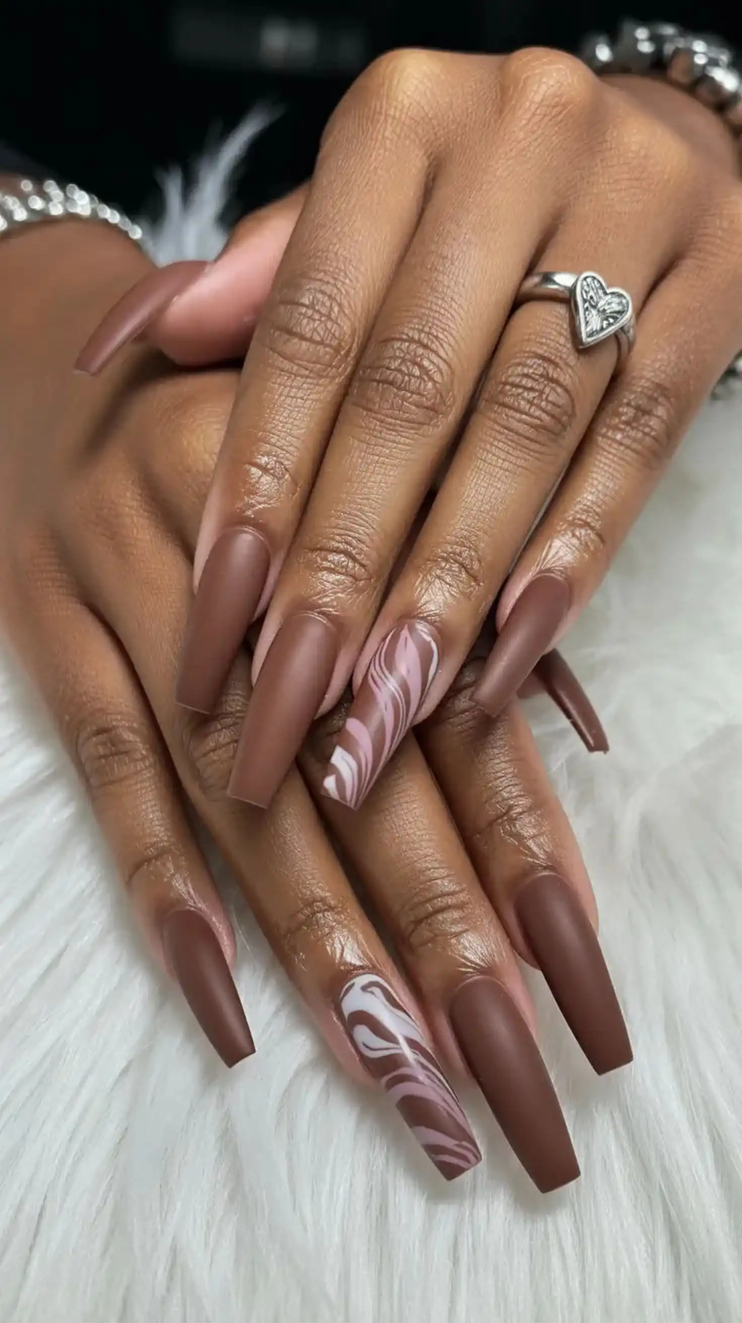 Chocolate brown long coffin nails creating dramatic statement neutral winter manicure design perfect for bold sophisticated style look