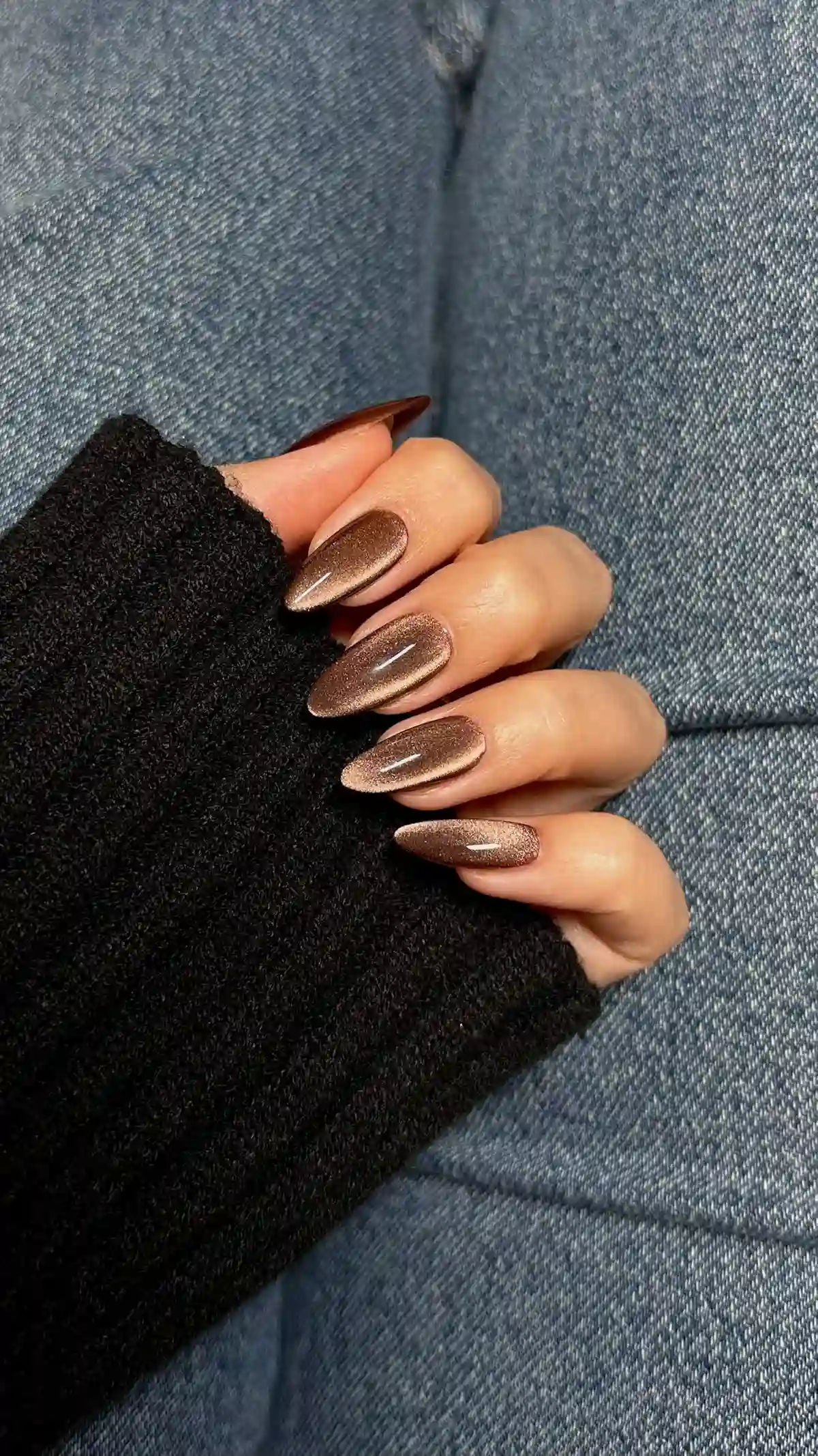 Chocolate velvet cat eye nails with magnetic dimensional finish creating trendy winter manicure with light catching brown effect