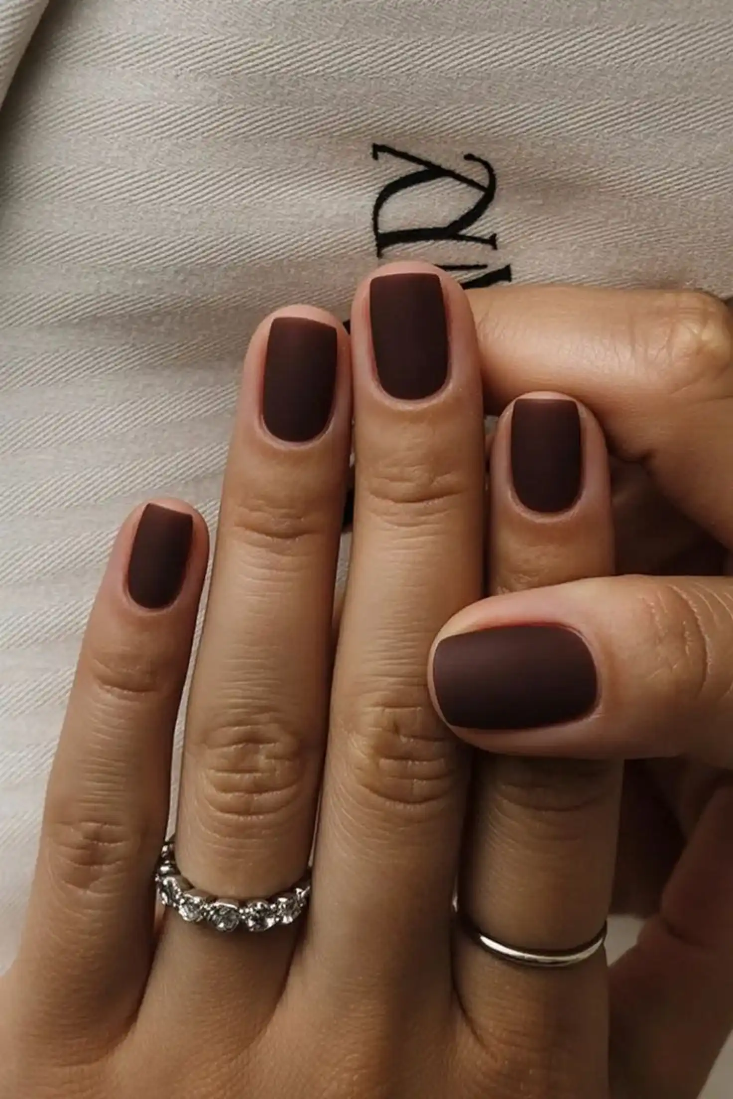 Milk chocolate squoval nails with medium brown color creating versatile neutral winter manicure style perfect for everyday fashion