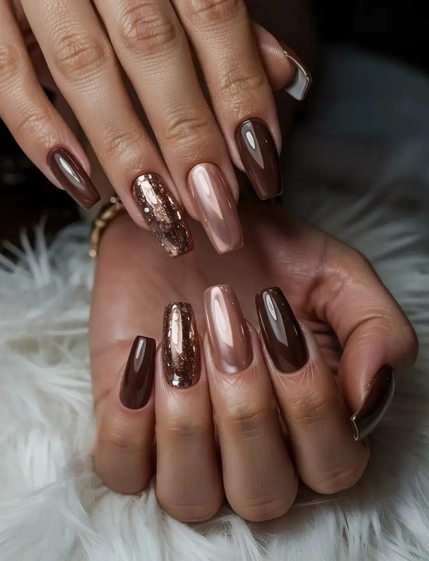 Mocha brown chrome nails with metallic finish creating trendy Pantone 2025 winter manicure perfect for elevated neutral style look