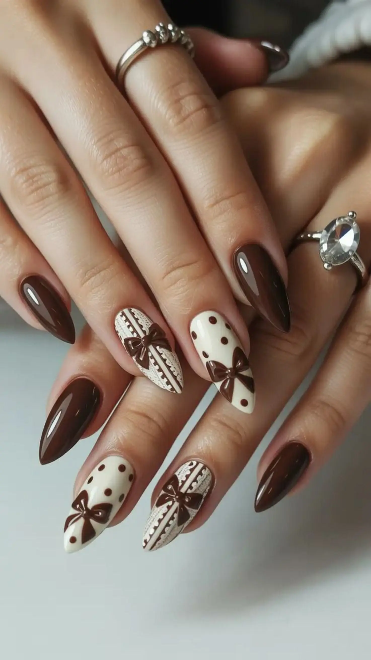 Rich chocolate brown almond shape nails creating classic neutral winter manicure design perfect for everyday sophisticated style 2025