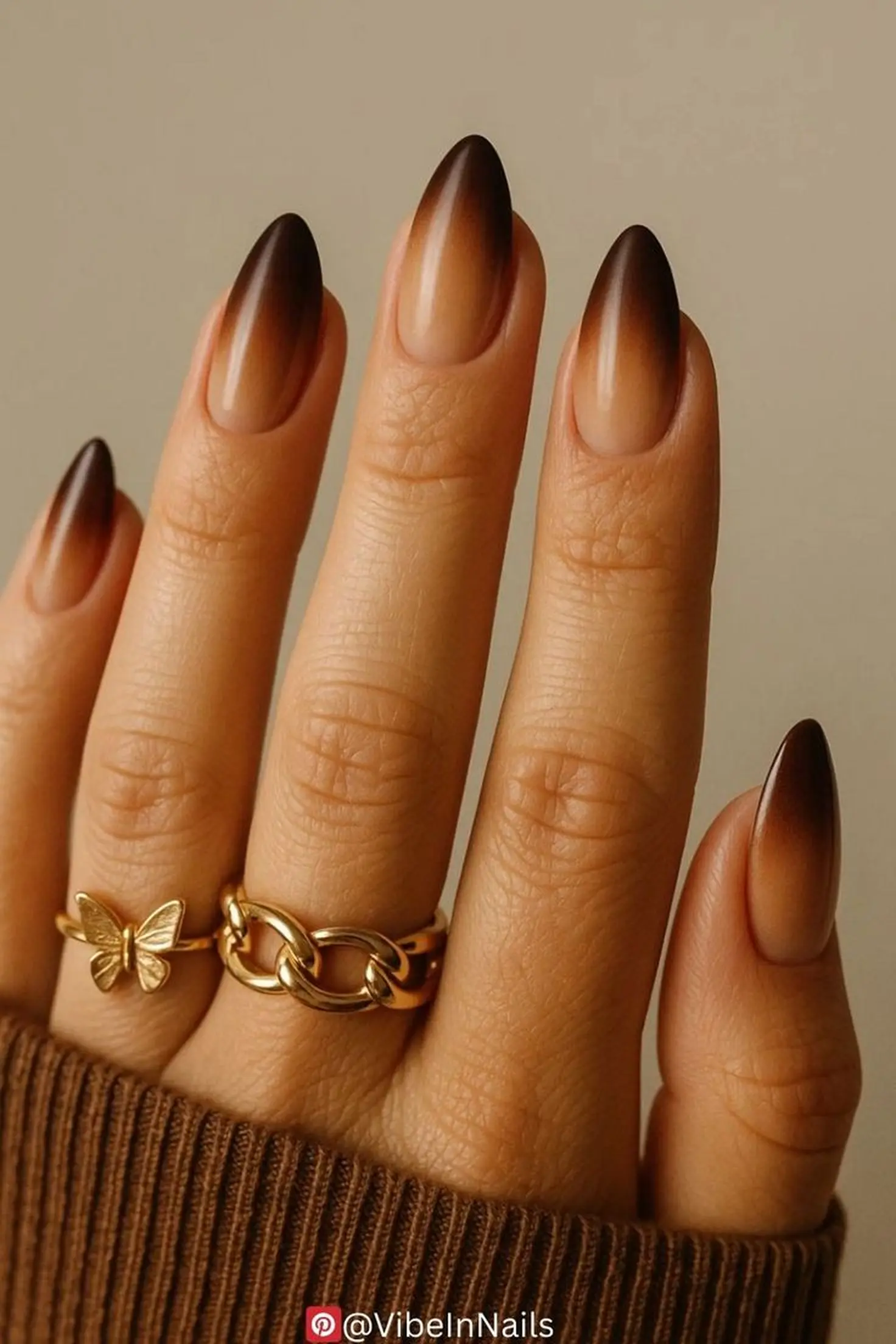 Warm brown to nude gradient nails with ombre transition creating natural elegant winter manicure design perfect for neutral lovers