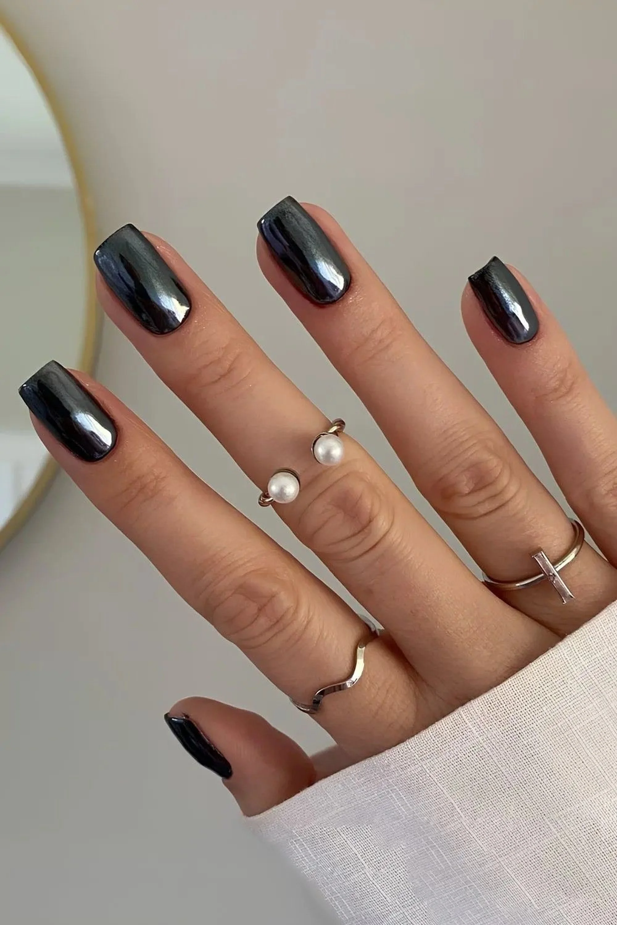 Black chrome short nails with dark metallic finish creating sleek modern winter manicure perfect for minimalist edgy style 2025