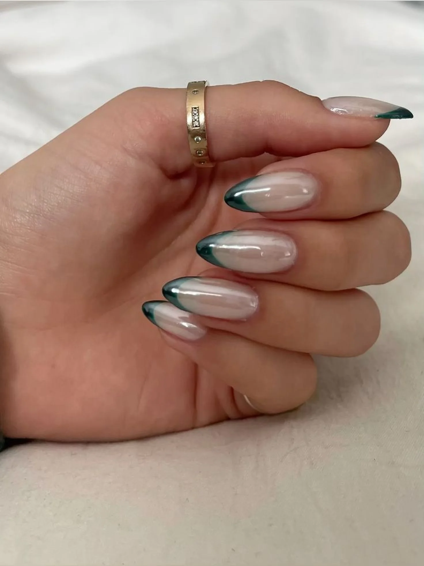 Mint chrome French tips with green metallic accent creating fresh modern winter nail art perfect for unique seasonal manicure design