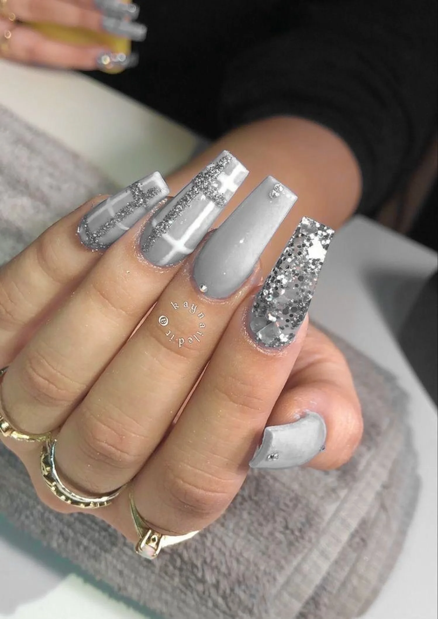 Silver glitter chrome long coffin nails with sparkly metallic finish creating bold statement winter manicure for party season